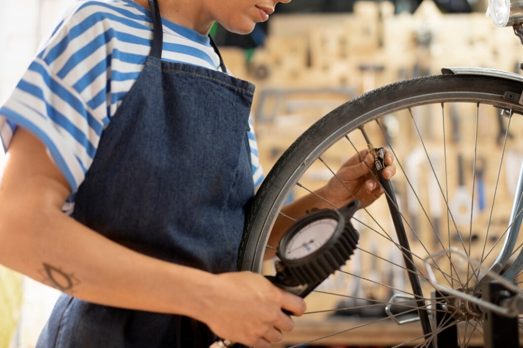 close-up-worker-checking-bike-wheel_23-2149103875.jpg