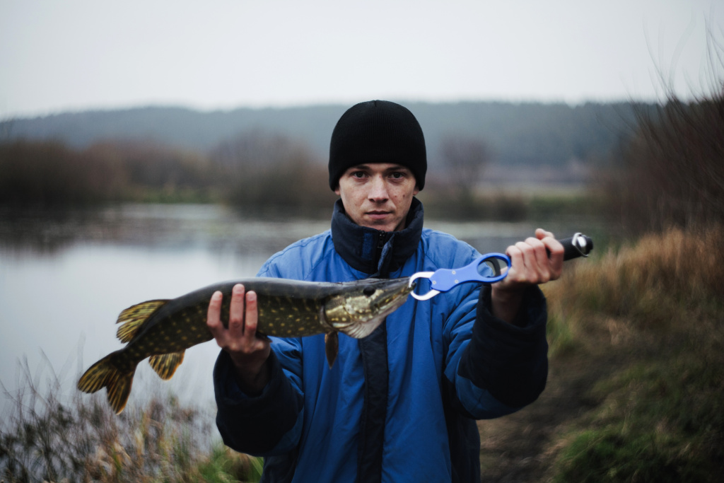 portrait-man-holding-pike-fish.jpg